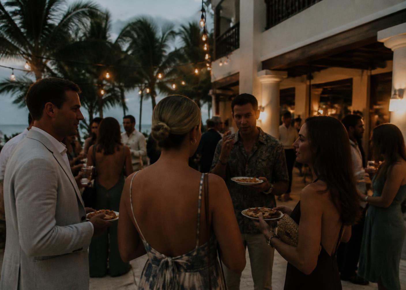 Guests gathered outdoors at an evening celebration in the Riviera Maya